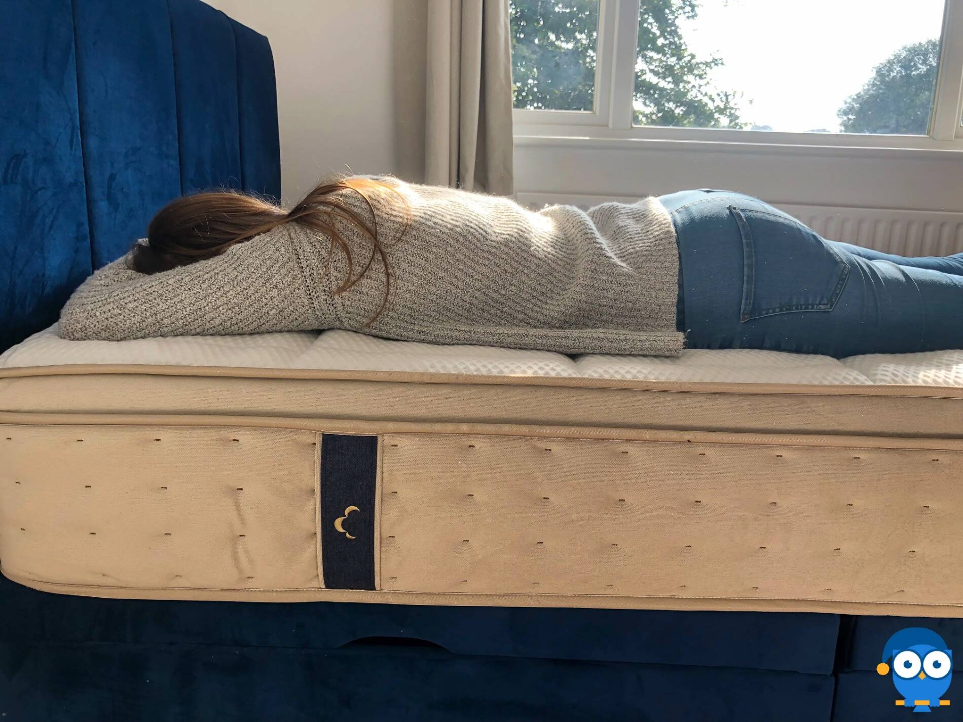Lady sleeping on the front on a Dreamcloud mattress.
